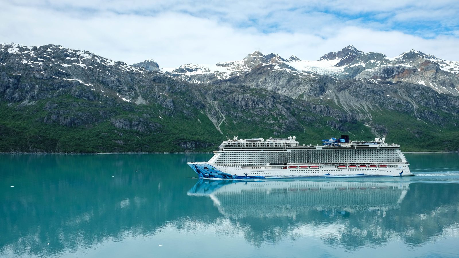 A cruise ship sailing past a glacier in Alaska