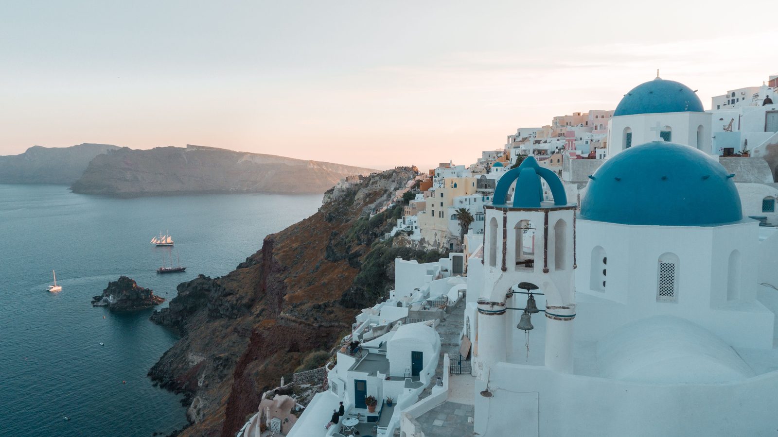 Blue-domed churches above the sea in Santorini, Greece
