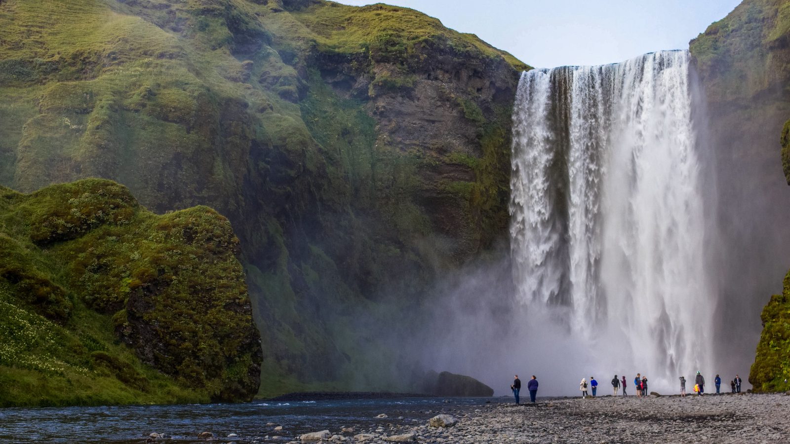 Skógafoss waterfall in the green landscape of Iceland