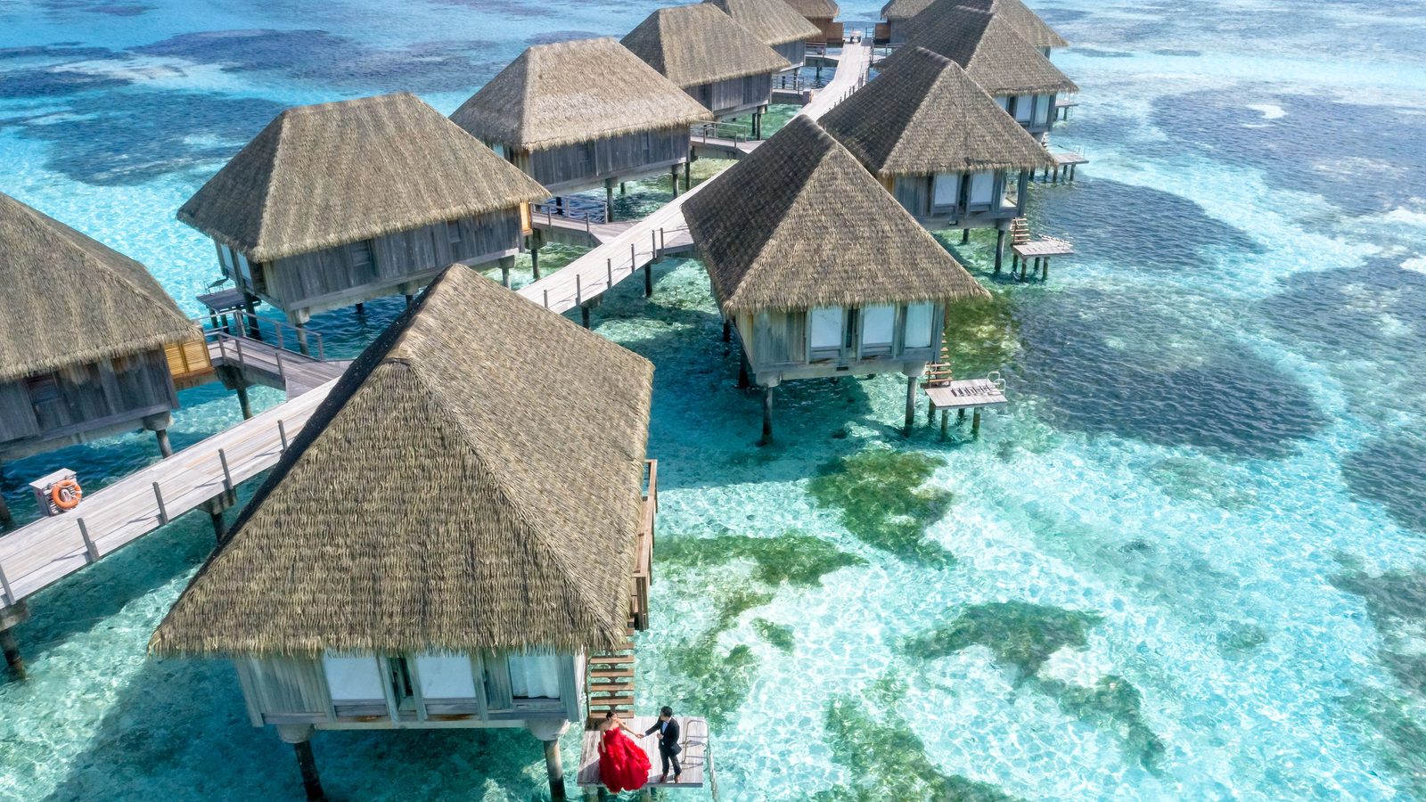 Overwater villas above turquoise lagoons in the Maldives